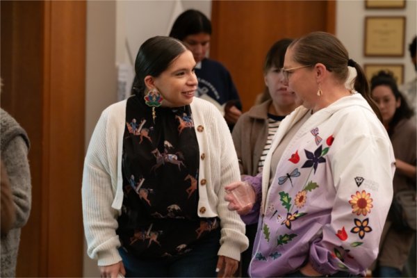 Attendees mingle while leaving the event.