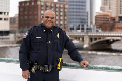 Chief Eric Payne stands in uniform on a bridge in Grand Rapids