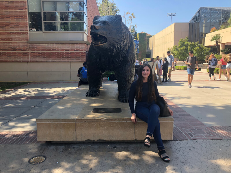 woman by bear statue on UCLA campus