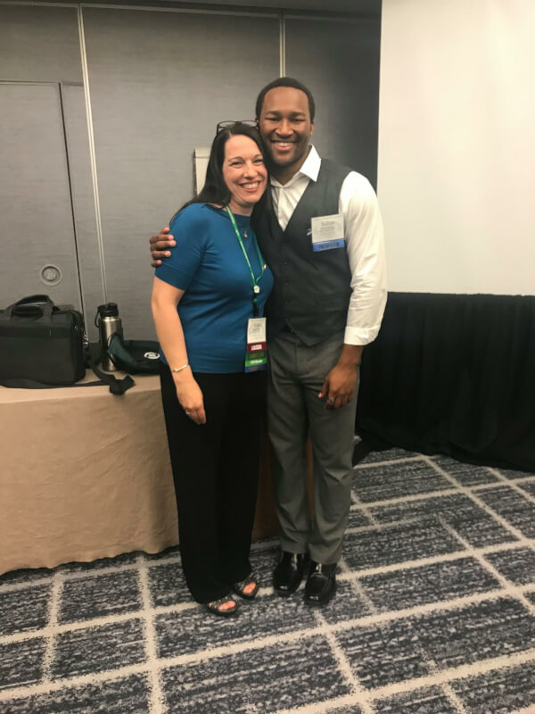 man and woman standing together at conference