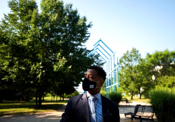 Kyle Boone, GVSU's new director of housing, stands outside near the Transformational Link structure on the Allendale Campus.