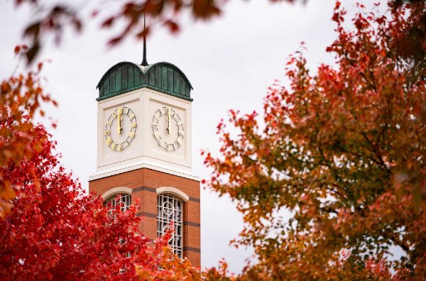 The carillon is seen with red and orange leaves in the foreground.