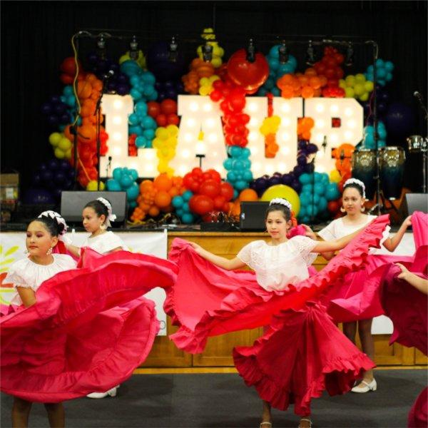 Four young girls dance at the Latin Americans United for Progres Fiesta Week 2023.