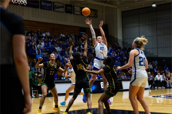 Sophomore MacKenzie Bisballe shoots over a crowd of Wayne State defenders.