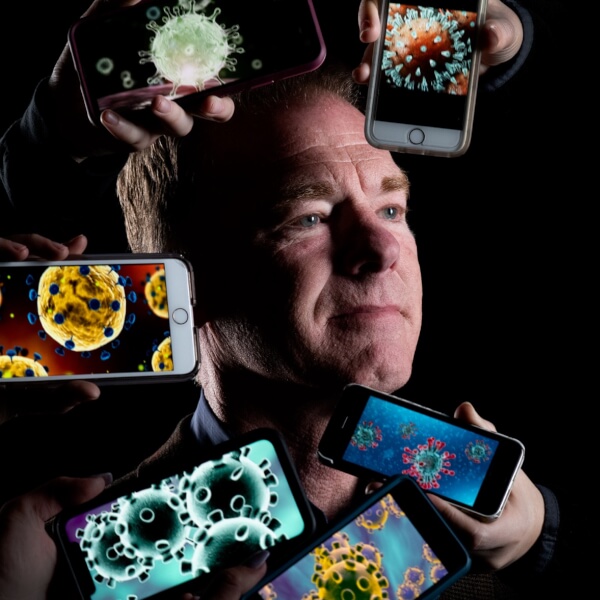 man with phone photos representing the coronavirus near his head