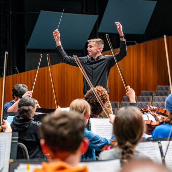 GVSU Orchestra Director Joel Schut conducting during a performance of the featured piece