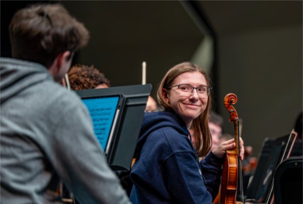 Aveline Schienke looks back at follow orchestra member during a break