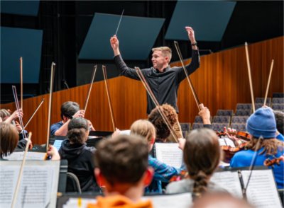 GVSU Orchestra Director Joel Schut conducting during a performance of the featured piece