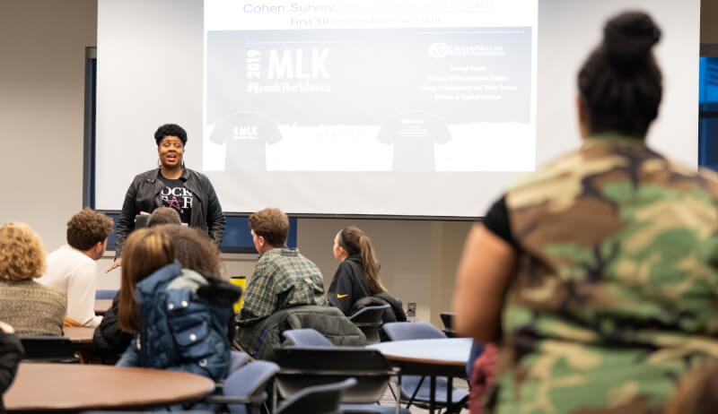 woman in front of audience answering question