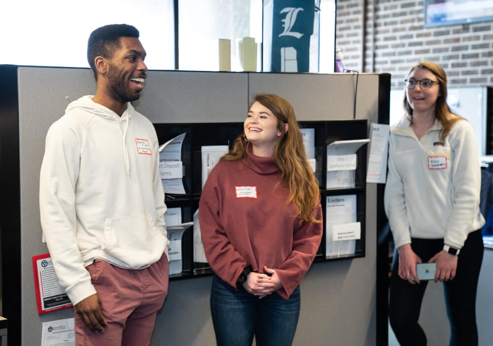 Grand Valley Lanthorn staff at a celebration for the newspaper's 100th newsstand.