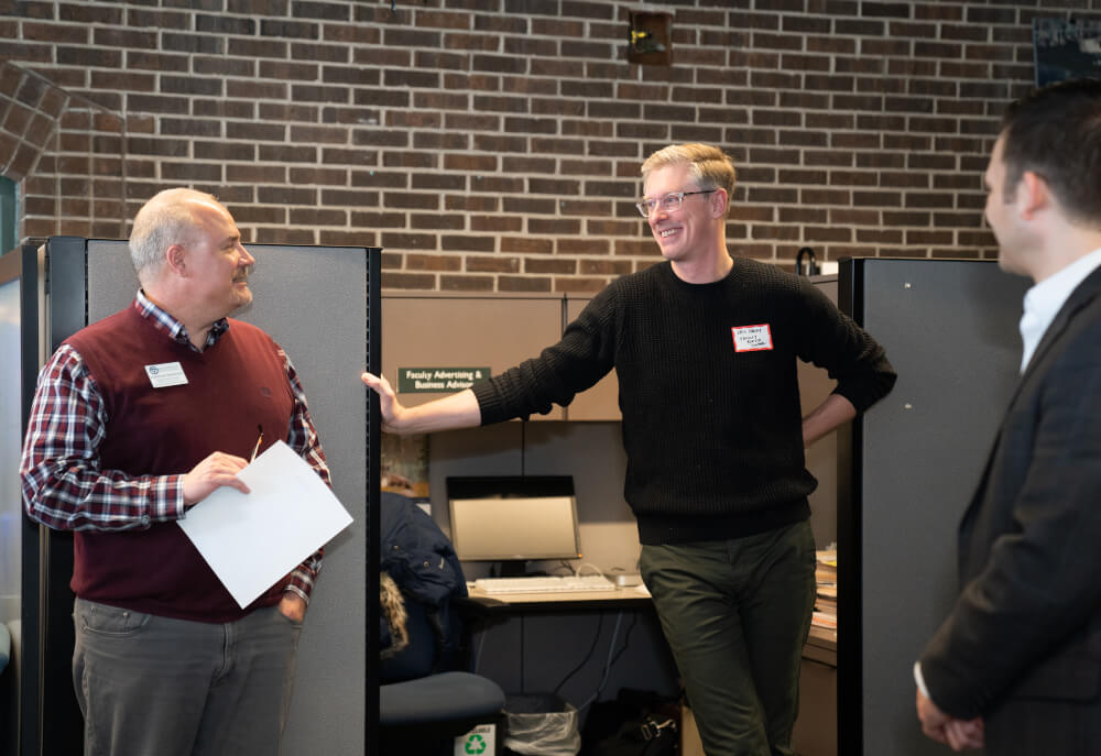 Lanthorn advisers at a celebration for the newspaper's 100th newsstand.