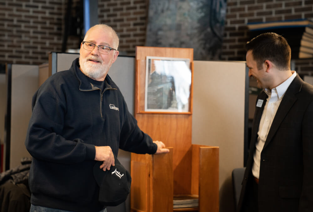 Former Grand Valley Lanthorn adviser at a celebration for the newspaper's 100th newsstand.