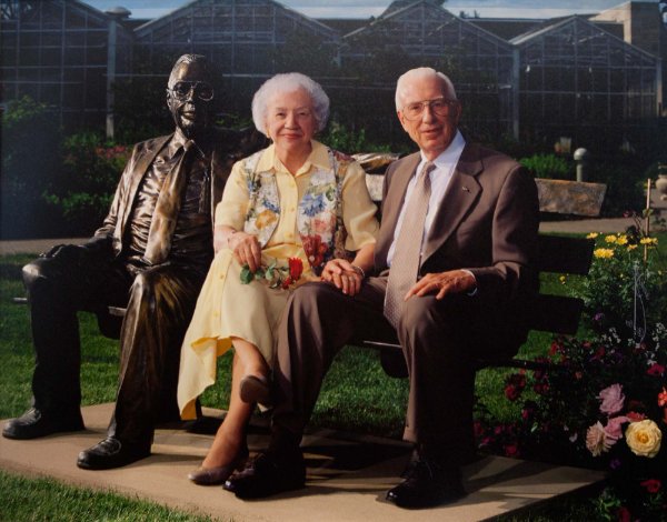 Lena and Fred Meijer next to a statue of Fred at Meijer Gardens and Sculpture park.