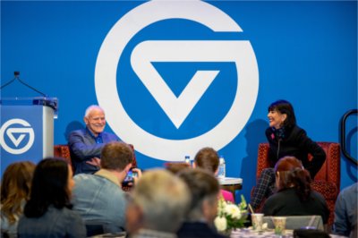 President Philomena V. Mantella and biologist Leroy Hood share a laugh on stage during their Tech Week event at Grand Valley.