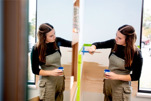 Lara Hinze paints the wall at Little Red Dentistry