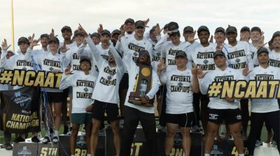 The Grand Valley men's track and field team celebrate its national championship on the podium.