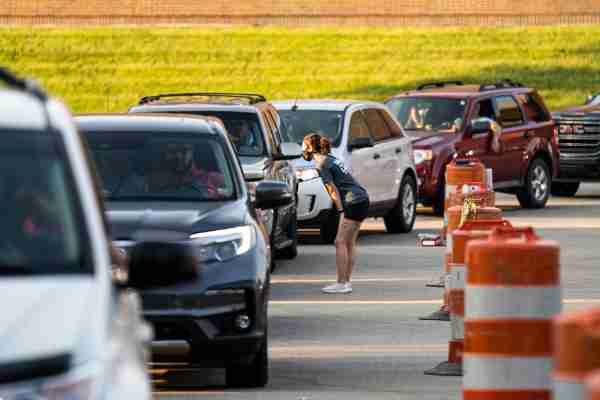 A line of cars waits to enter campus during move-in on Monday, August 24.