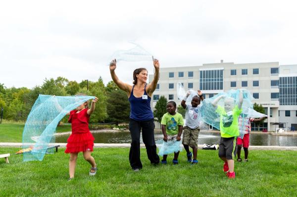 Hannah Seidel, GVSU associate professor of dance, leads children in Dancing by the Pond during Friends and Family Day of the Big Splash Week