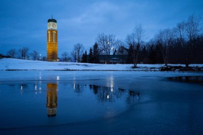 Cook Carillon Tower is in background, reflecting on Zumberge Pond.