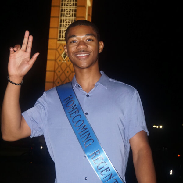 man standing in front of carillon tower