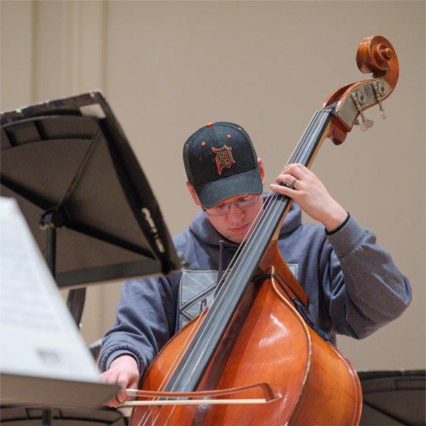 Cullen DeCou plays the bass on stage