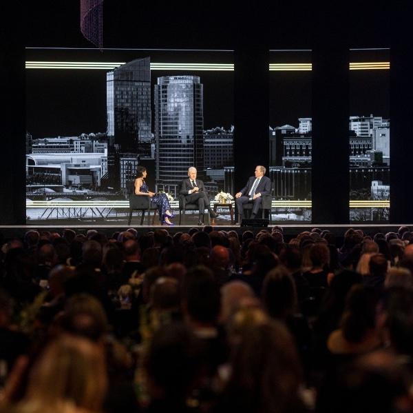 President Mantella sits on a stage with former Presidents Bill Clinton and George W. Bush.