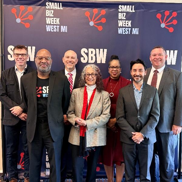 A posed photo showing leaders of Small Biz Week at a press event.
