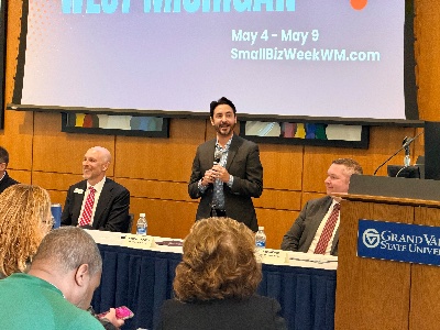 Guillermo Cisneros addresses a crowd during a news conference announcing Small Biz Week.