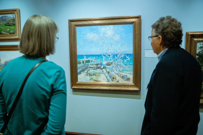 Visitors to the Gordon Gallery admiring one of the more than 150 works of art by Mathias Alten in Grand Valley's collection.