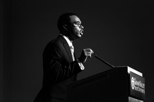 Julian Sanders delivers remarks in a black and white photo