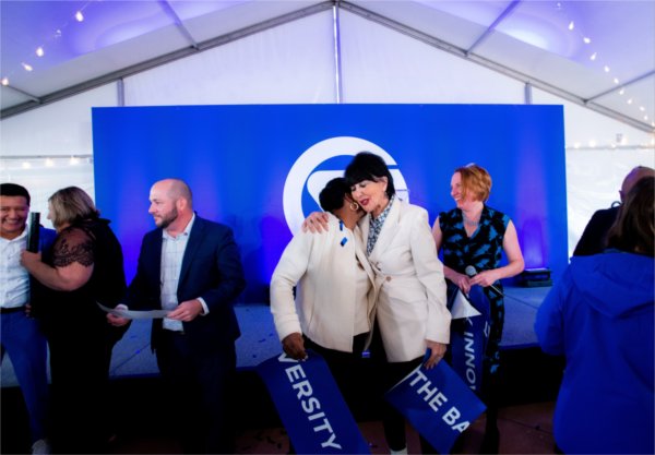 President Philomena V. Mantella, right, hugs La June Montgomery Tabron, president and CEO of the W.K. Kellogg Foundation, following the Battle Creek Innovation Hub ribbon cutting ceremony October 9.