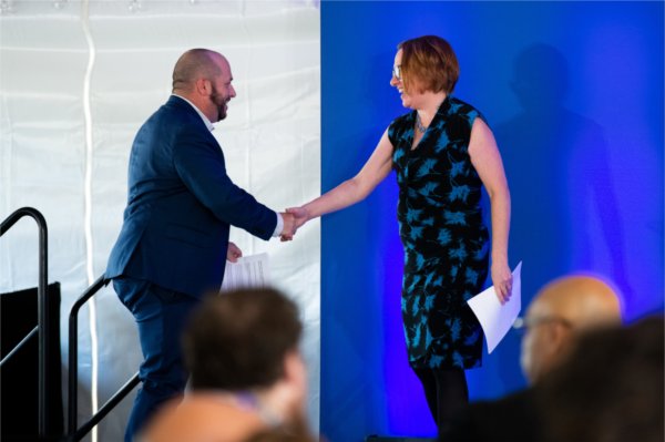 Kara Van Dam, vice president and chief executive for GVSU Omni, welcomes Joe Sobieralski to the stage to give remarks.