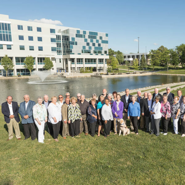 group photo in front of pond