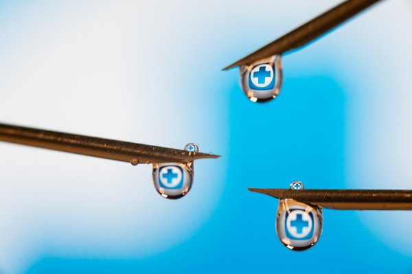 water droplets with a blue cross inside are pictured in an illustration