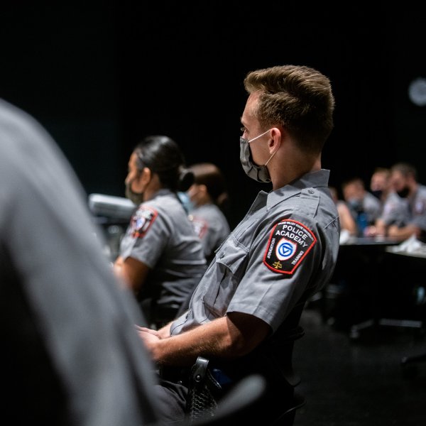 Police Academy cadet listens in class