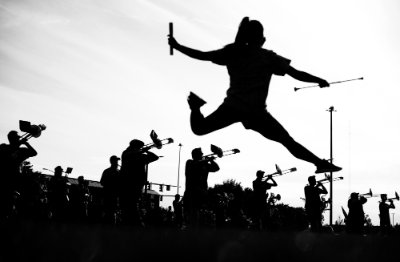 A twirler leaps through the air.
