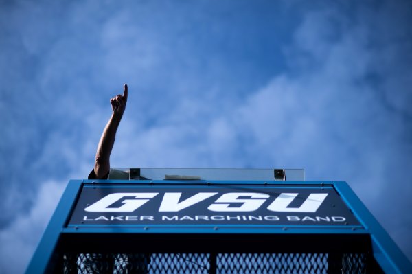 A person points from the band tower.