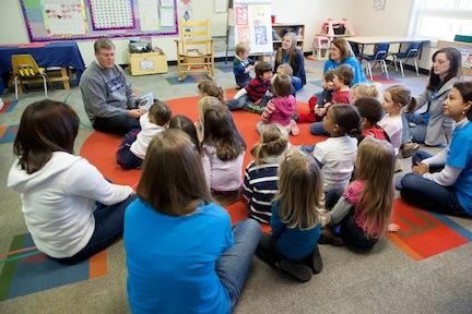 President Thomas J. Haas reads to children at the Children's Enrichment Center.