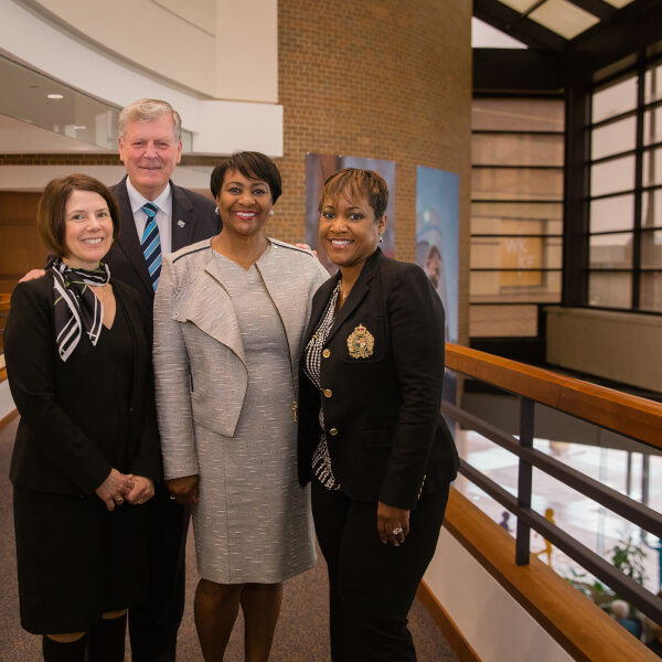 Four people standing in a row