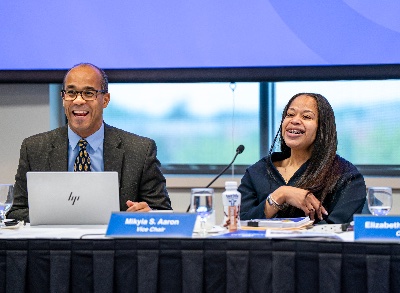 Newly elected GVSU Board Vice Chair Ronald Hall and Chair Mikyia Aaron smiling during a GVSU Board meeting.