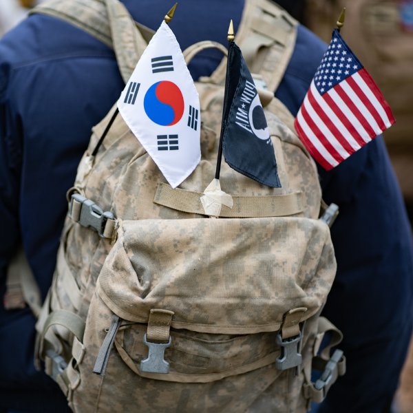 A student veteran's backpack is decorated with flags.