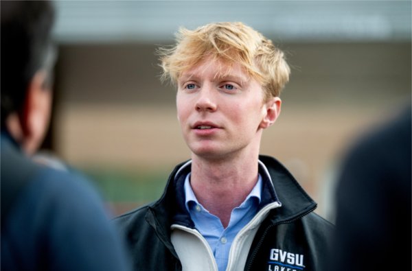 GVSU Student Senate President Lukas Hartley speaks with someone during the event.