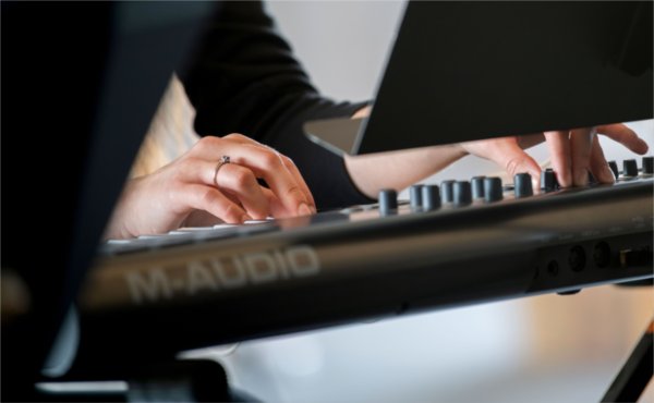 A detail of hands on a keyboard. 