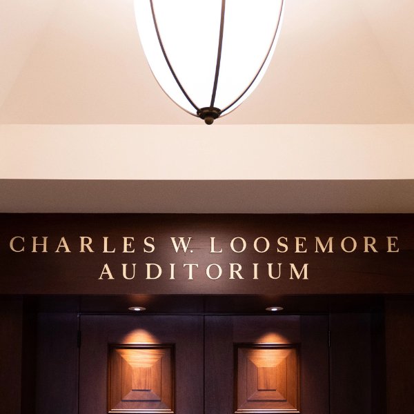 The entrance to the Charles W. Loosemore Auditorium, with the name posted above the doors.