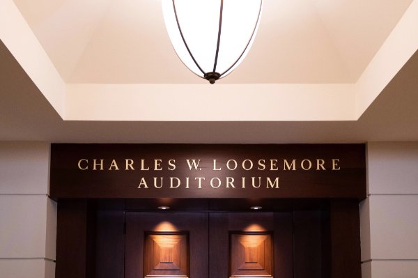 The entrance to the Charles W. Loosemore Auditorium, with the name posted above the doors.