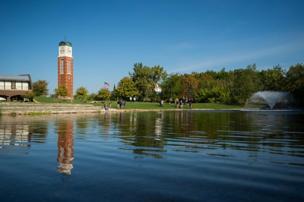 Students studying near Zumberge pond by the Cook Carillon Tower.