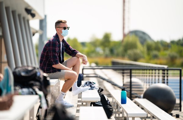 Dr. David Burkard watches the track and field team practice. The Staying in Place order requires a licensed physician monitor team practices to ensure COVID-19 protocols are followed.