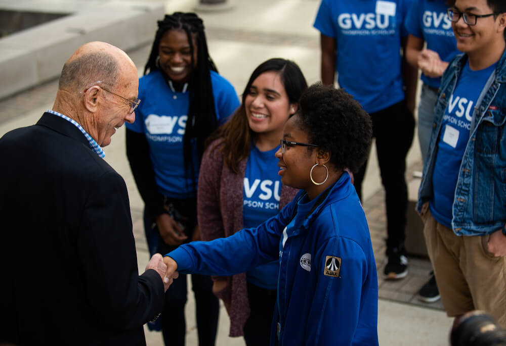 man shaking hands with student