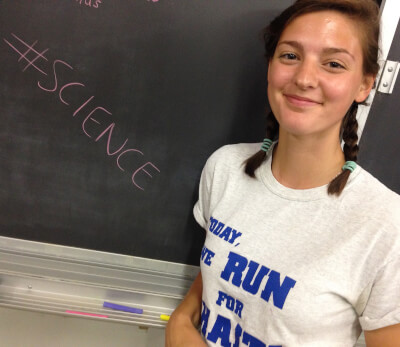 woman in front of chalkboard