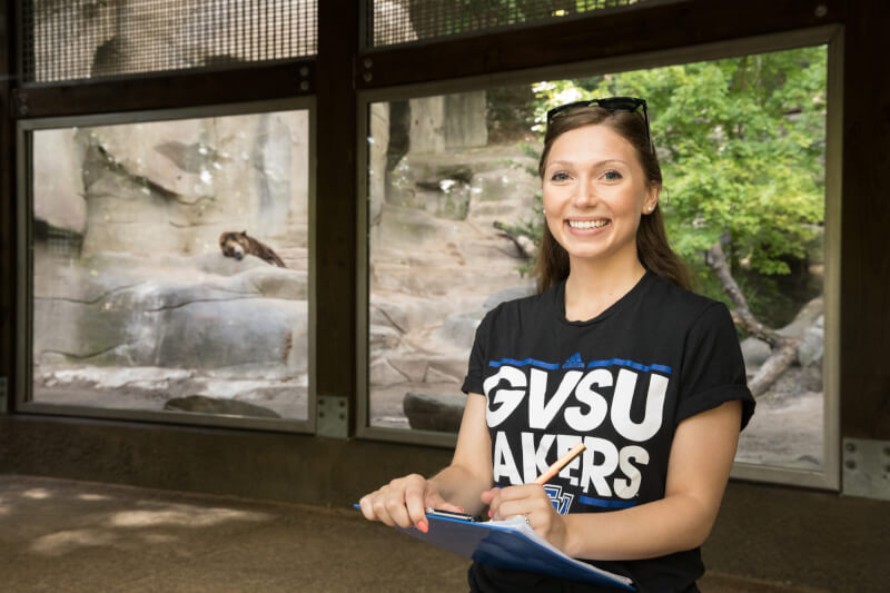 woman in front of bear habitat at zoo